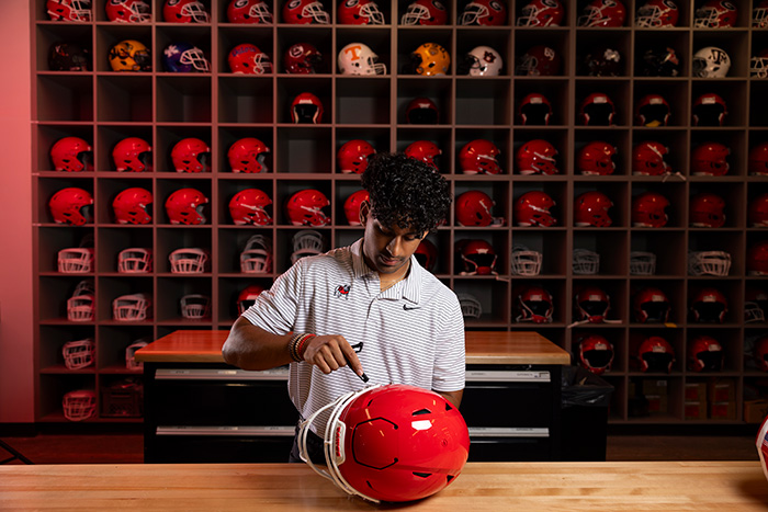Jayan Patel working with football equipment
