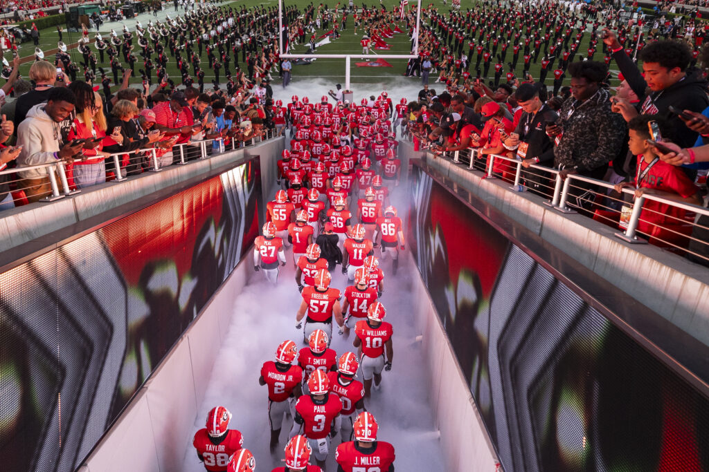 Overhead view of the football team running onto Dooley Field from the west end zone tunnel during the football team runout at the UGA vs. UAB football game.