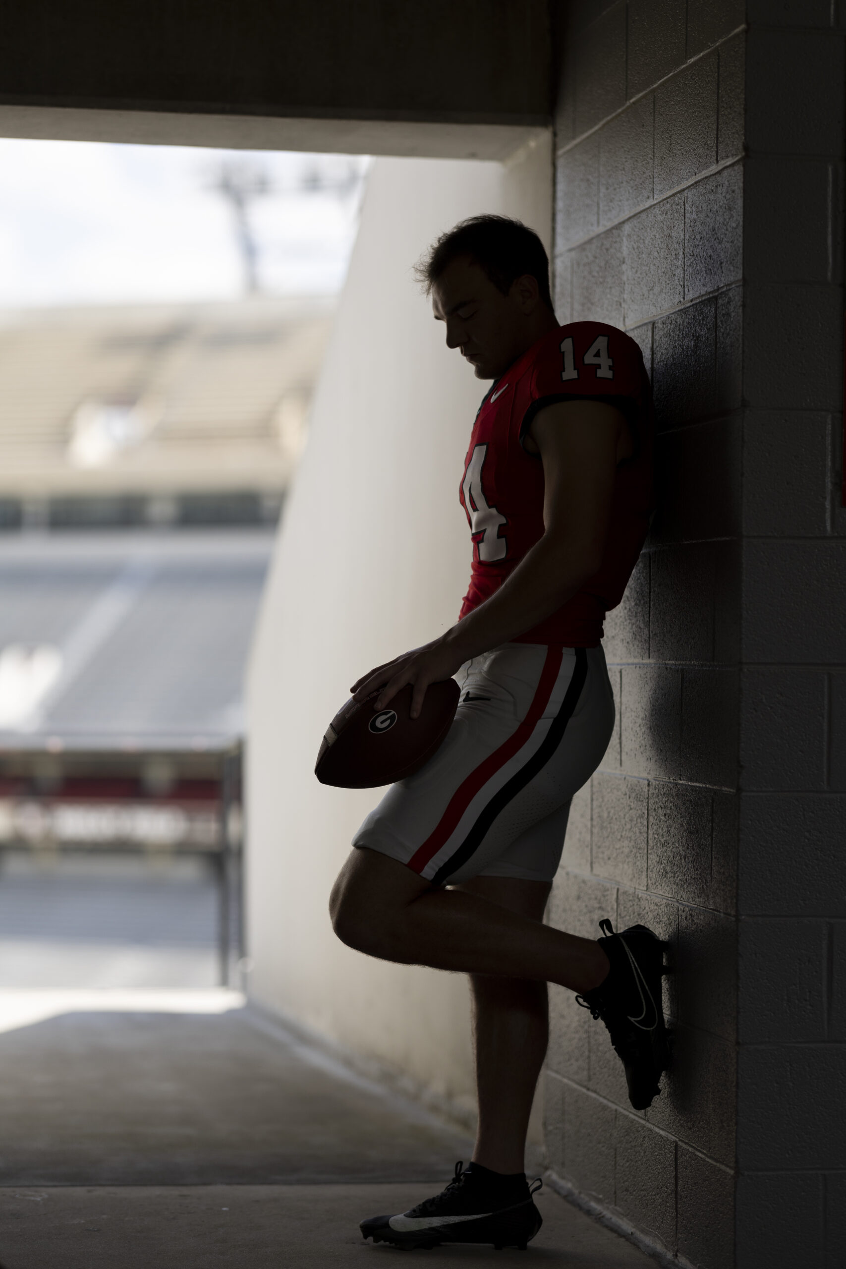 Portrait of red shirt sophomore quarterback Gunner Stockton in a tunnel at Sanford Stadium.