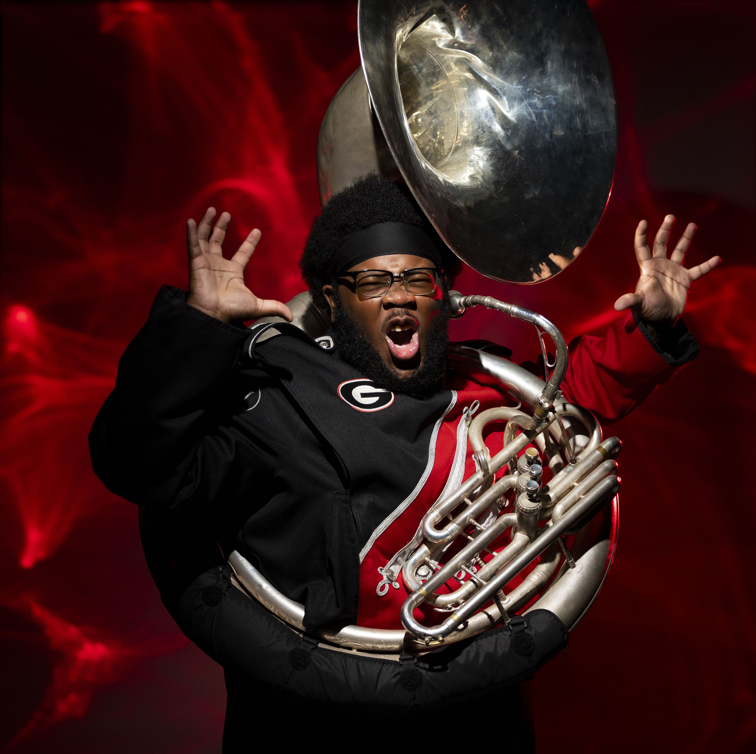 Portrait of Redcoat Marching Band tuba player Travis Mansfield in the photography studio at the Georgia Center.