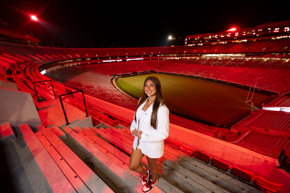 Portrait of Alexandra Milano of The Georgia Way inside Sanford Stadium at night. Portrait is for the Fall Season Game Changers profile.