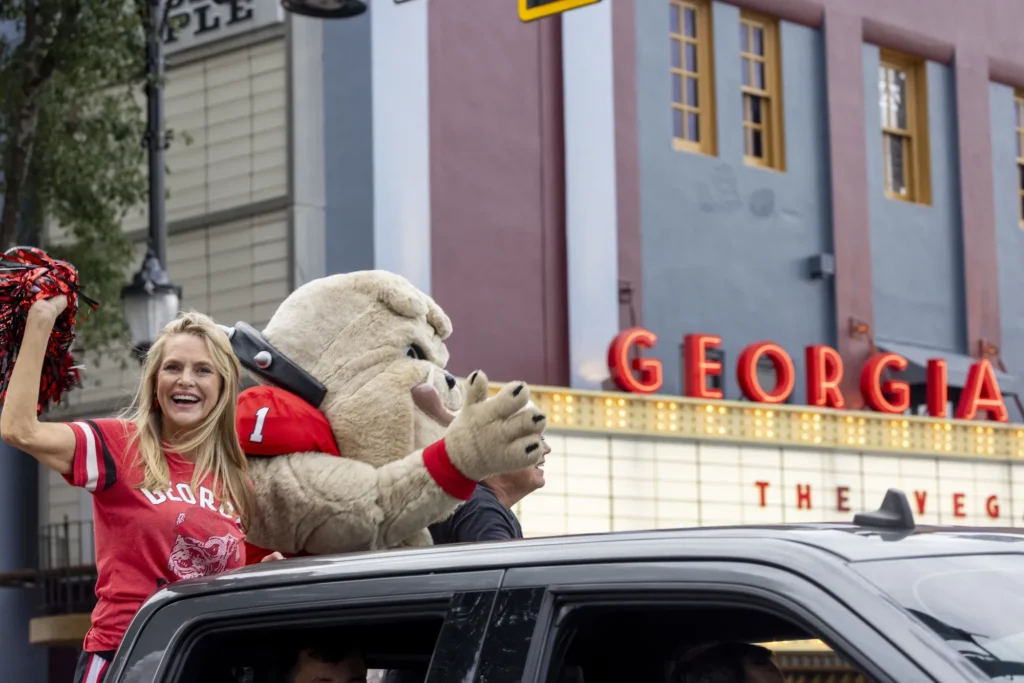 Hairy Dawg rides through town in the back of a black pick up truck as he greets his fans.