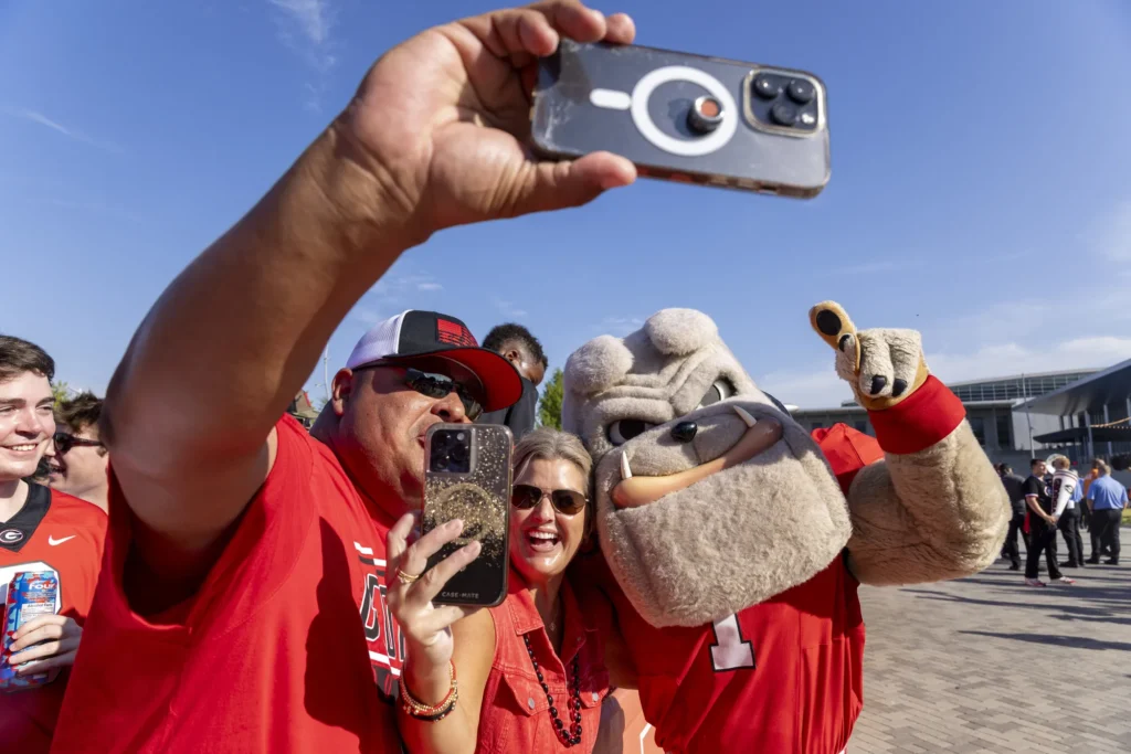 UGA's bulldog mascot takes a selfie with Georgia Bulldog fans.