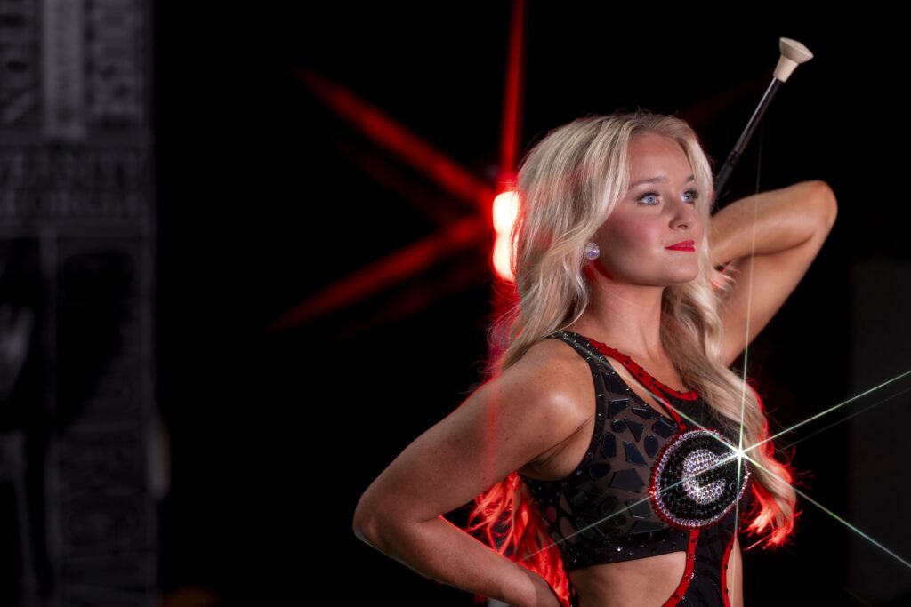Baylie Jade Phillips poses while looking off camera and holding a baton behind her back.